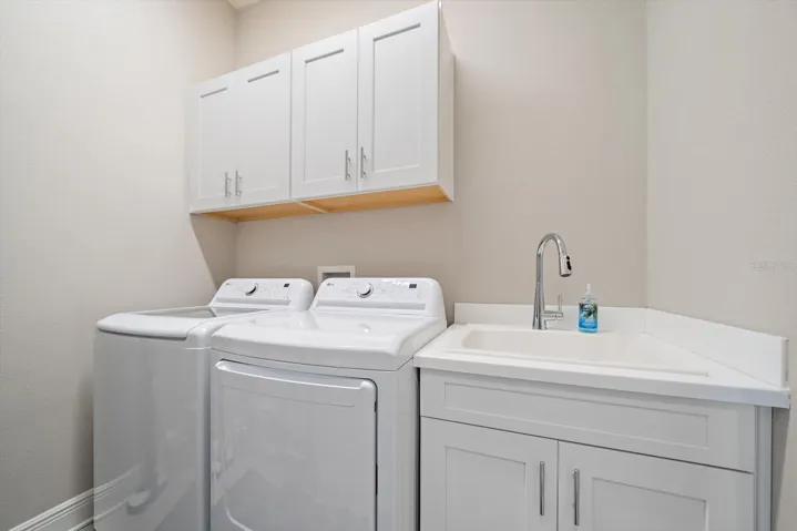 Laundry room with cabinets and laundry sink.