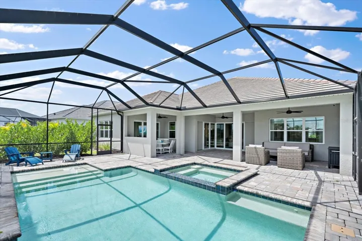 Heated Saltwater pool with infinity edge spa and sun shelf.