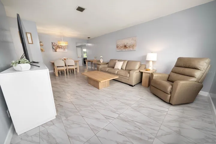 FAMILY ROOM. THIS VILLA STYLE CONDO IS PERFECT FOR ENTERTAINING FAMILY AND FRIENDS