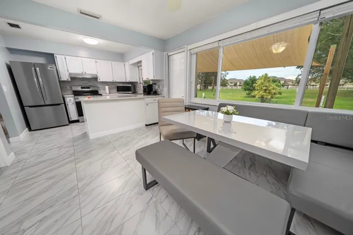 LARGE BREAKFAST KITCHEN NOOK, WITH KITCHEN & CLEAR VIEW OF POND & FOUNTAIN