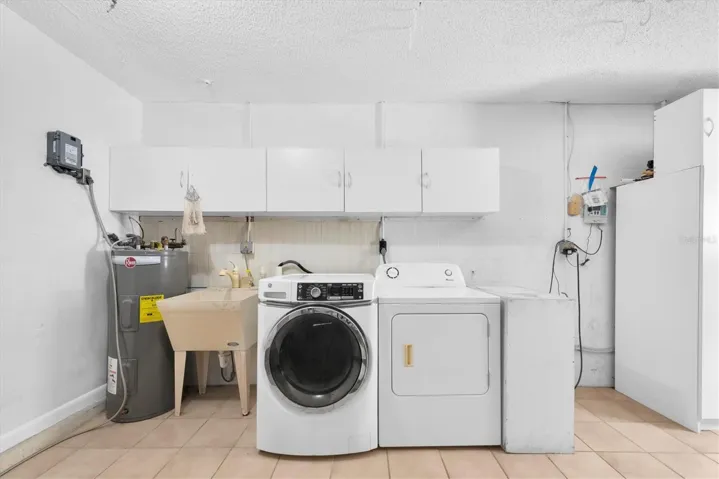 Two car garage with washer, dryer and cabinets for storage