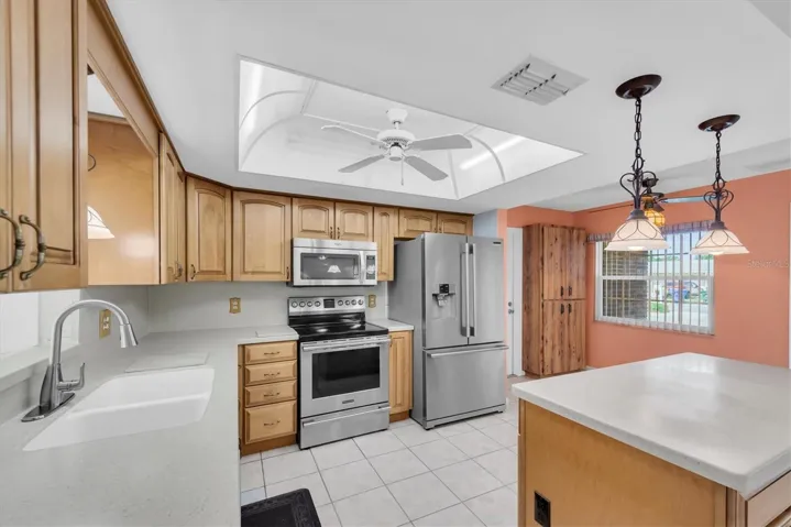 Kitchen with Corian countertops, wood cabinets, and Stainless Appliances