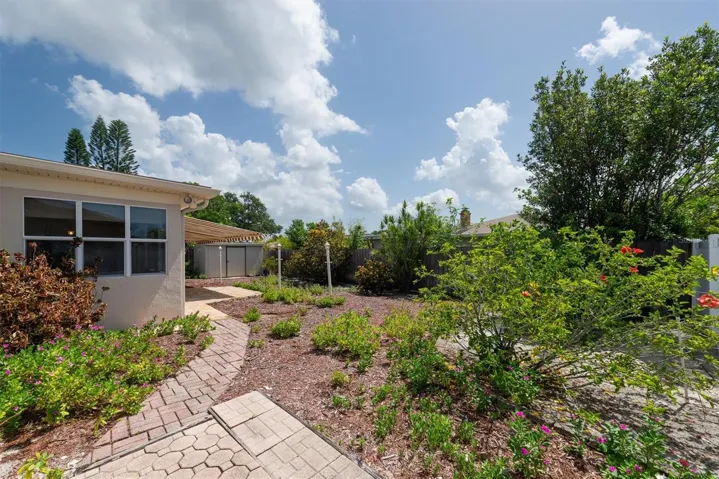 Back Patio with remote controlled Sun Shade Awnings, paver walkways, and storage shed with electricity