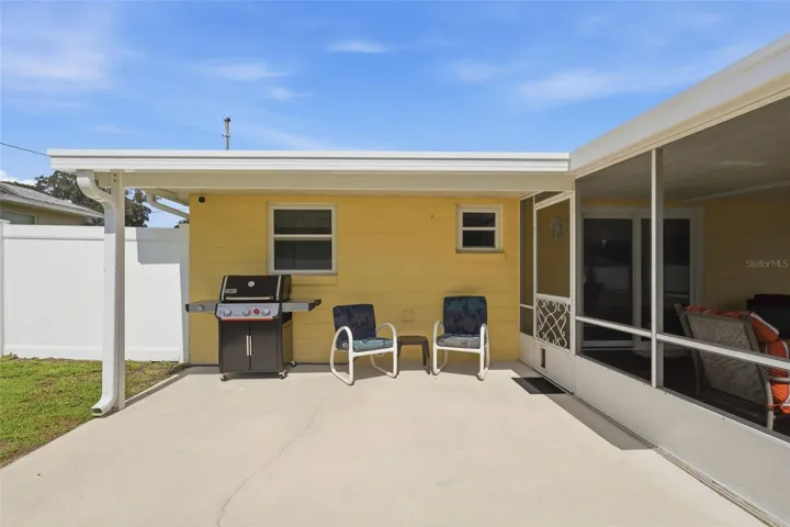 This unscreened area is perfect for barbecues. Roof section and gutters w/gutter guards new in 2026.