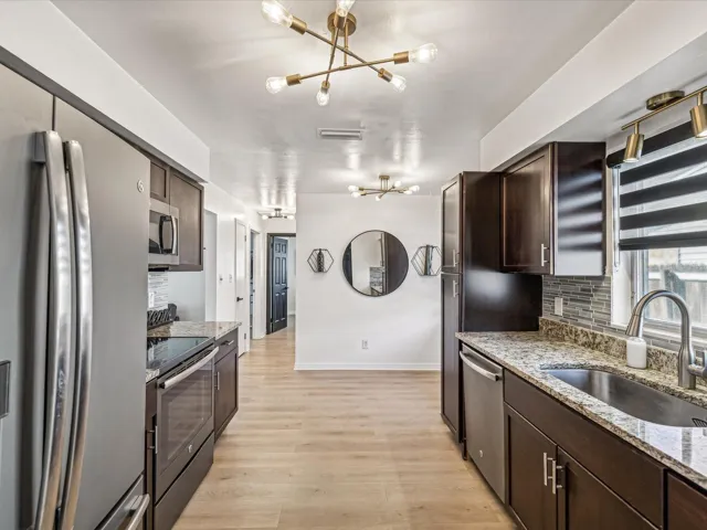 Kitchen with stainless steel appliances, granite countertops and wood cabinets