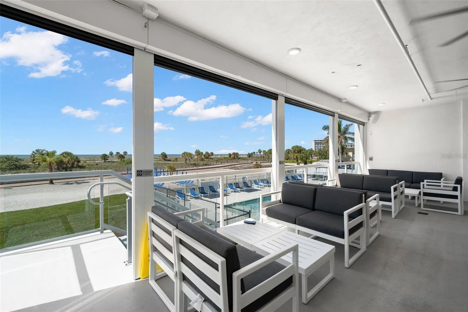 BAR LOUNGE AREA WITH STAIRS DOWN TO THE POOL DECK