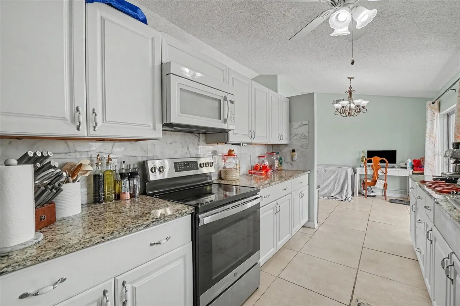 Galley kitchen with stone counters