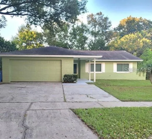 Front of Home with Large Driveway and Parking Pad