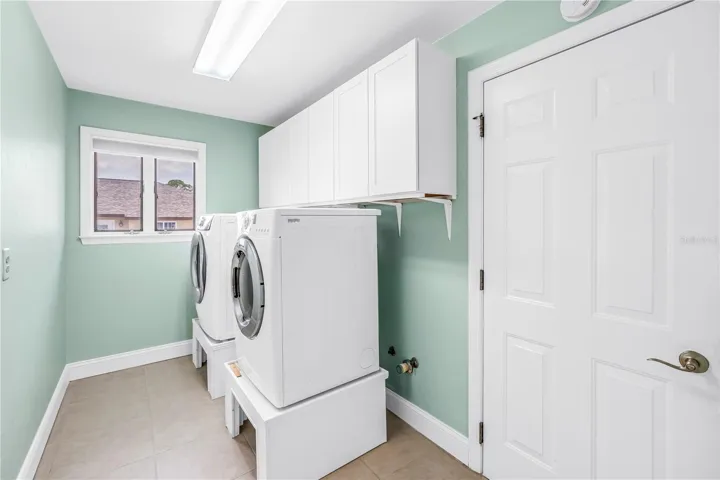 Large indoor laundry with storage - door leads to garage