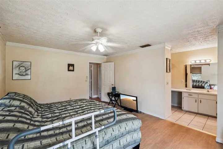 View of primary bedroom and entry to bathroom