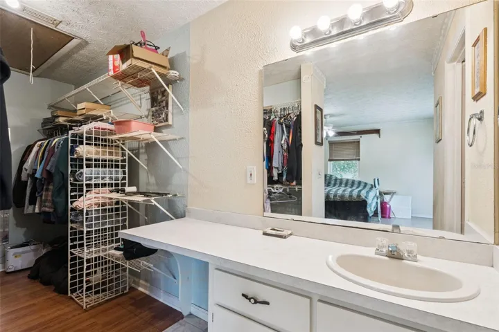 View of primary bedroom bathroom and walk in closet