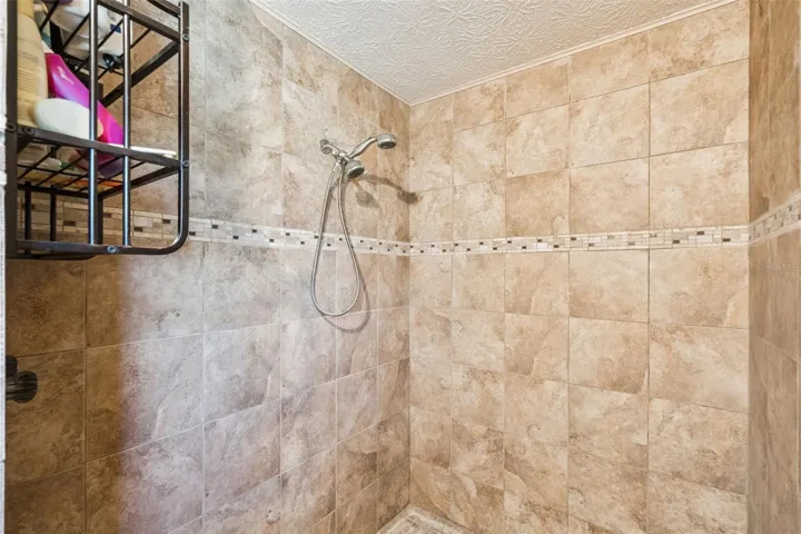 View of primary bedroom walk in shower