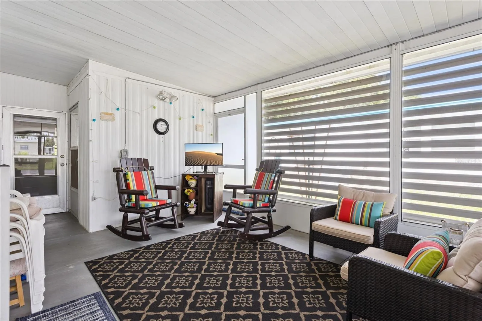 SCREENED LANAI IS BEHIND THE CARPORT AND GIVES PRIVACY TO YOUR OUTDOOR SPACE.