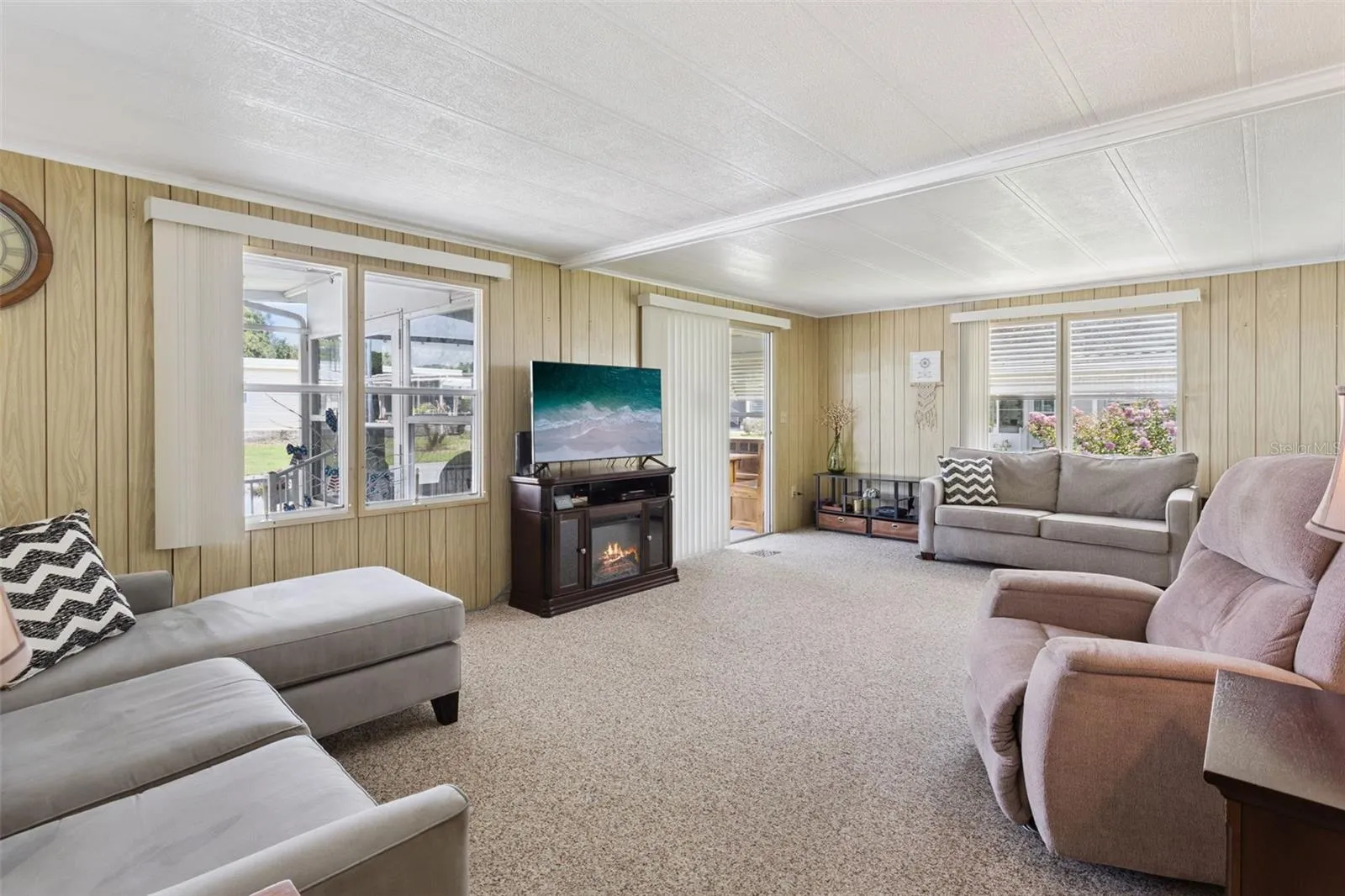 THE LIVING ROOM HAS A COZY FREE-STANDING FIREPLACE TO STAY COZY ON A CHILLY WINTER NIGHT.