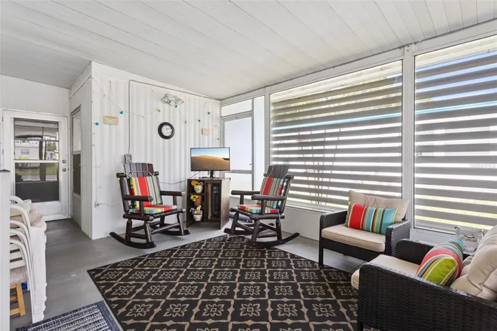 SCREENED LANAI IS BEHIND THE CARPORT AND GIVES PRIVACY TO YOUR OUTDOOR SPACE.
