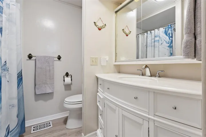 PRIMARY BATHROOM HAS A LOVELY UPDATED VANITY WITH LOTS OF STORAGE SPACE.