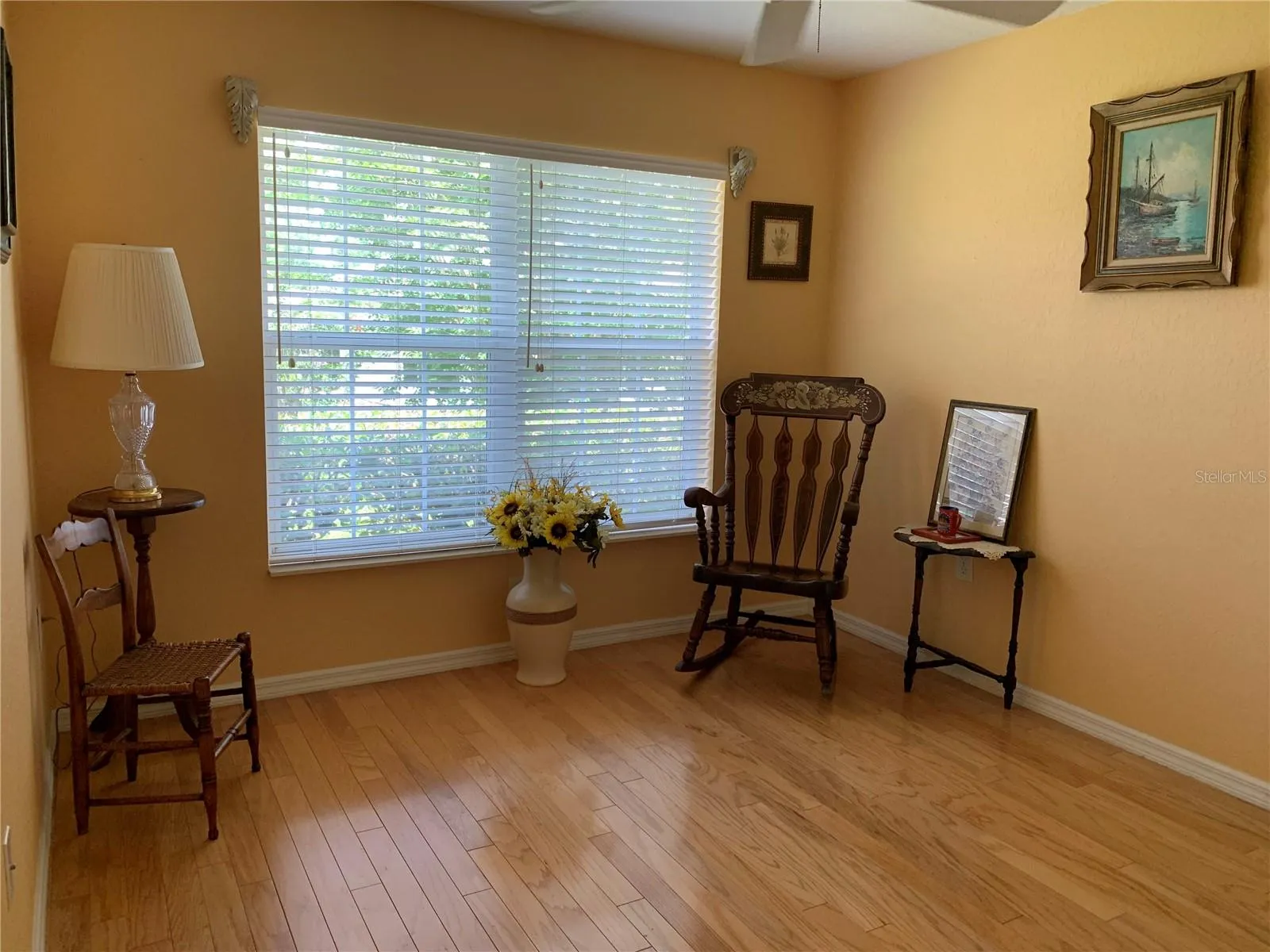 Guest bedroom, staged as reading room but comfortable to fit queen bed plus gorgeous wood floors continue