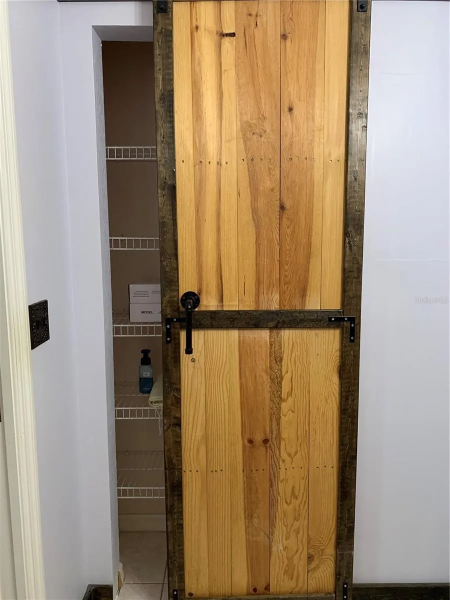 Linen closet in master bath with barn door