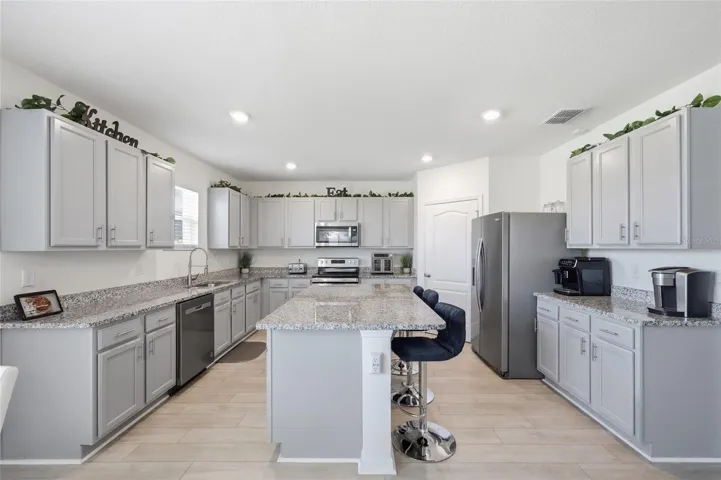 Open Kitchen with Granite Counter tops & stainless steel appliances