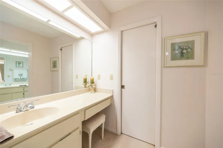 Two separate sinks one outside bathroom near walk in closet