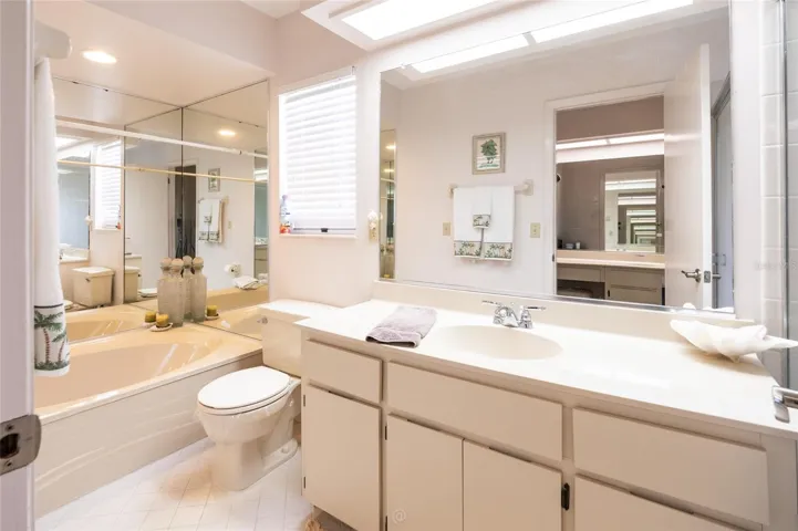 Another sink in bathroom with soaking tub on one side
