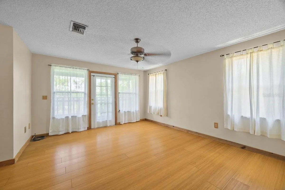 Primary bedroom with Bambi flooring, door to private back deck (2nd Floor)