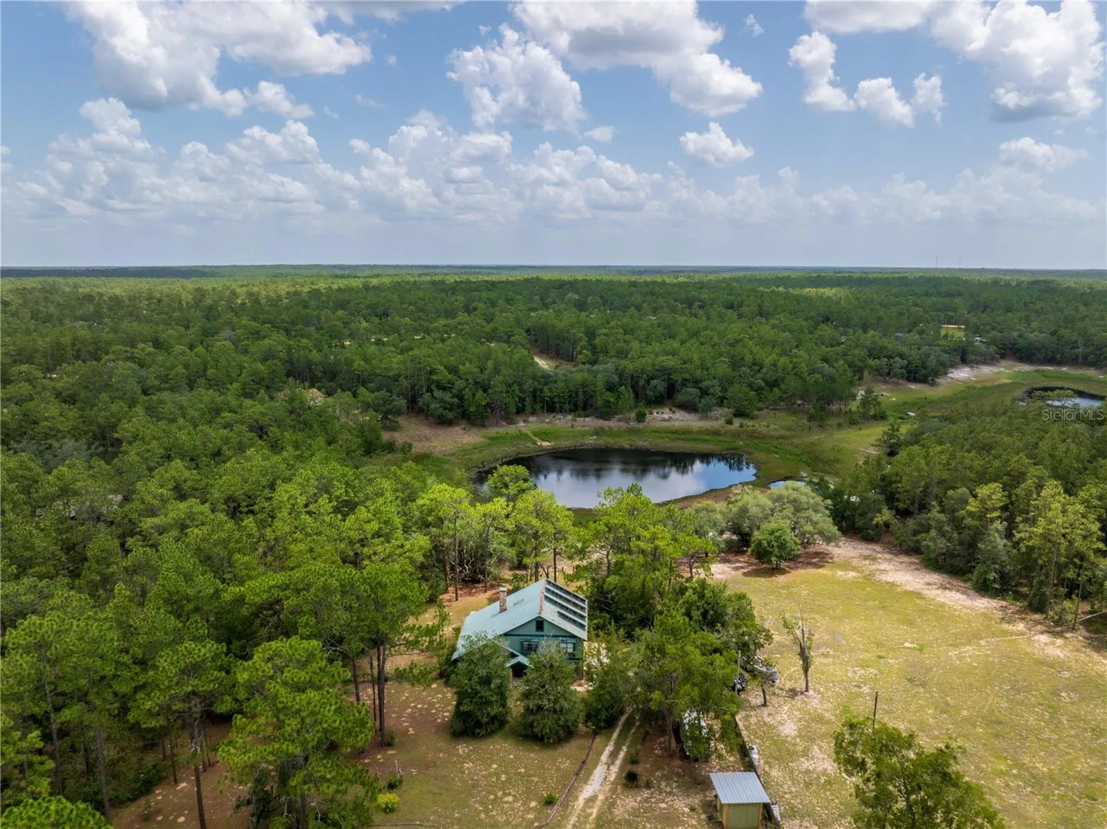 3.27+/- acres waterfront on Hour Glass lake AND Access to Fully recreational Cue Lake