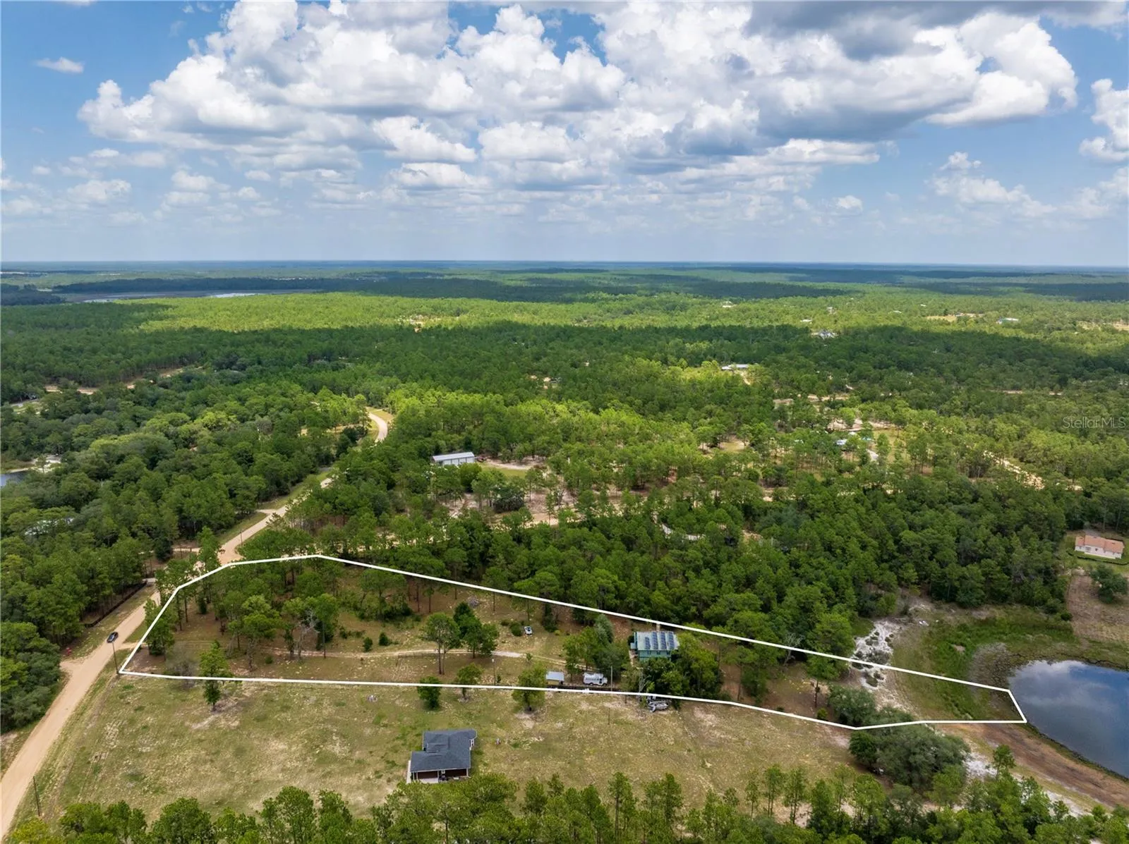 Corner Lot 3.27+/- acres waterfront on Hour Glass lake AND Access to Fully recreational Cue Lake