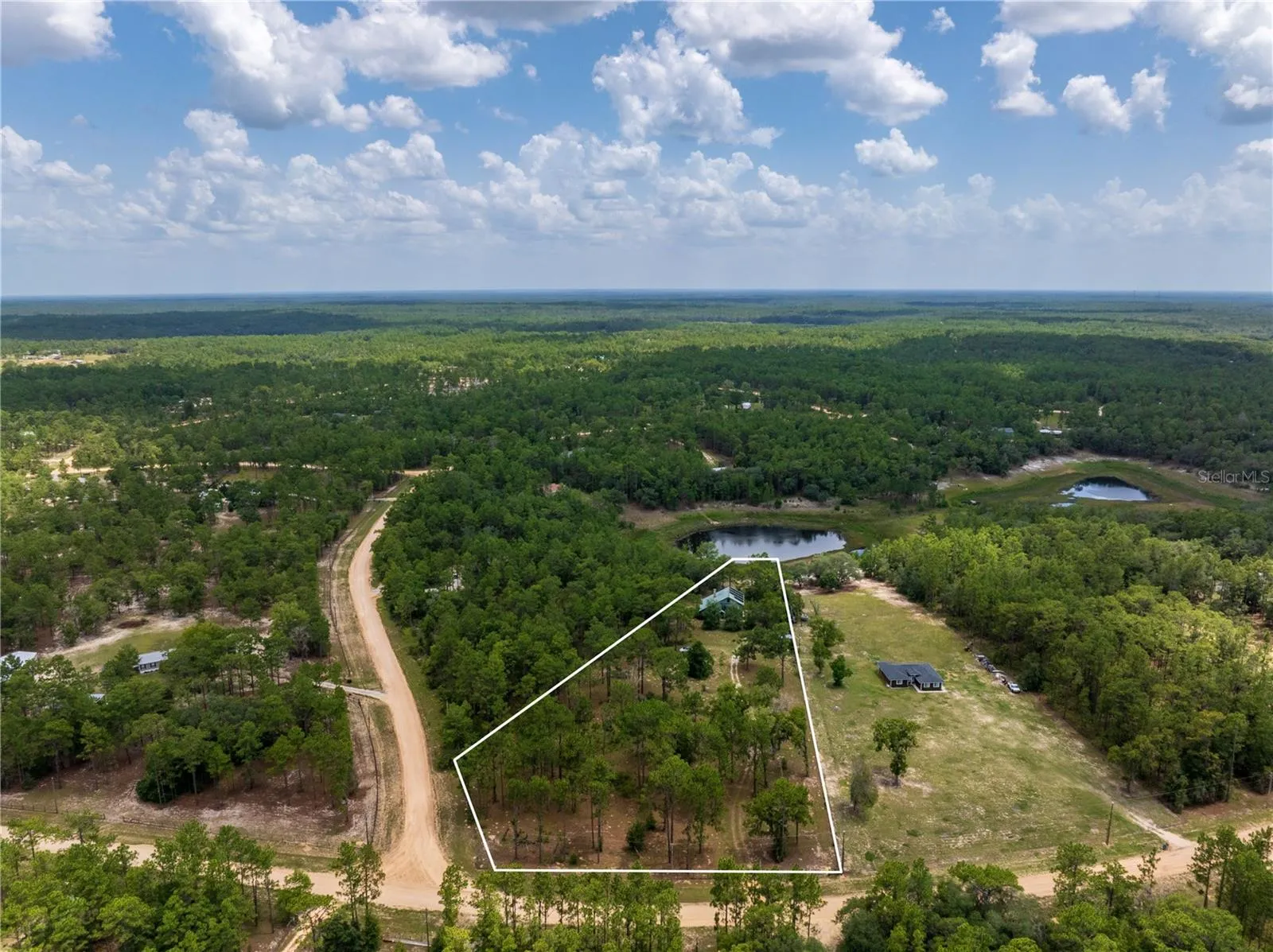 Corner Lot 3.27+/- acres waterfront on Hour Glass lake AND Access to Fully recreational Cue Lake