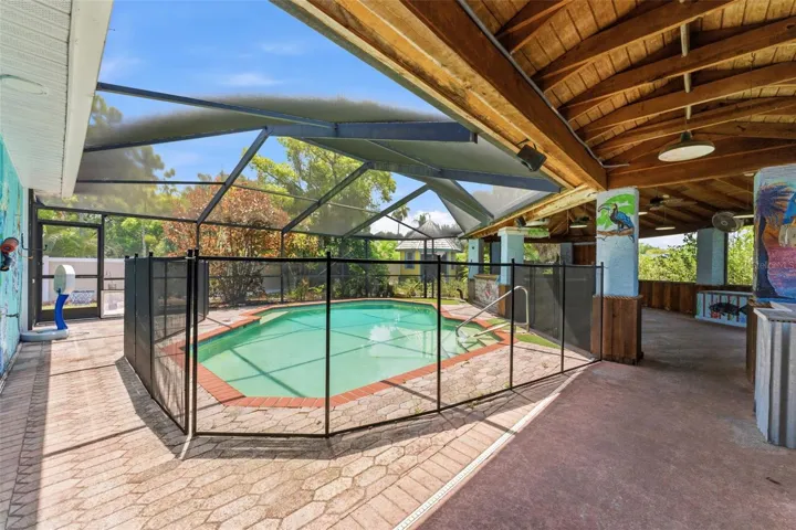 Screened in pool and tiki bar, covered area for ultimate outdoor living
