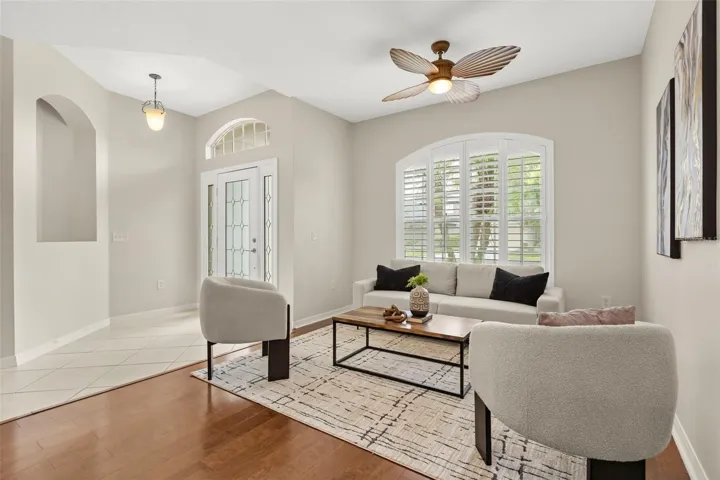Formal Living room/Dining room combination with gleaming laminate wood floors and custom shutters