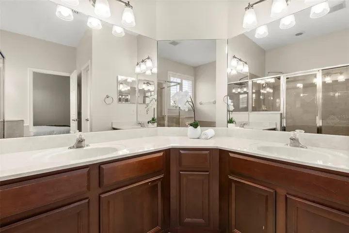 The spacious primary ensuite offers dual vanities, abundant cabinet and counter space, a relaxing soaking tub, and a separate walk-in shower.