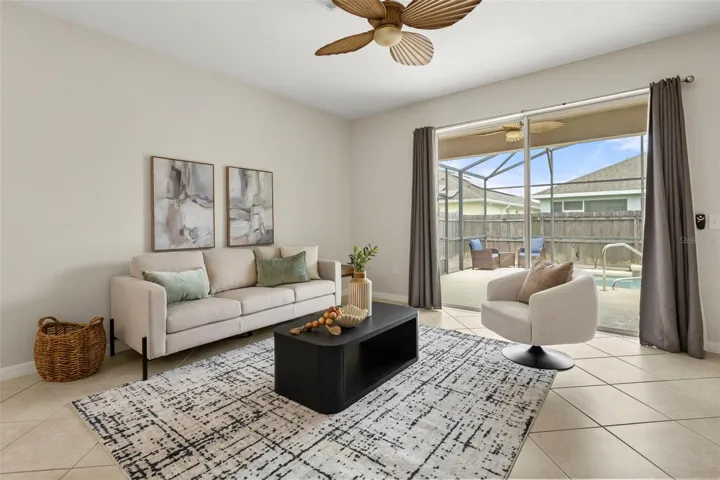 Bright and spacious, the family room is filled with natural light and opens through sliding glass doors to your private screened pool, covered lanai, and the perfect space for indoor-outdoor Florida living.