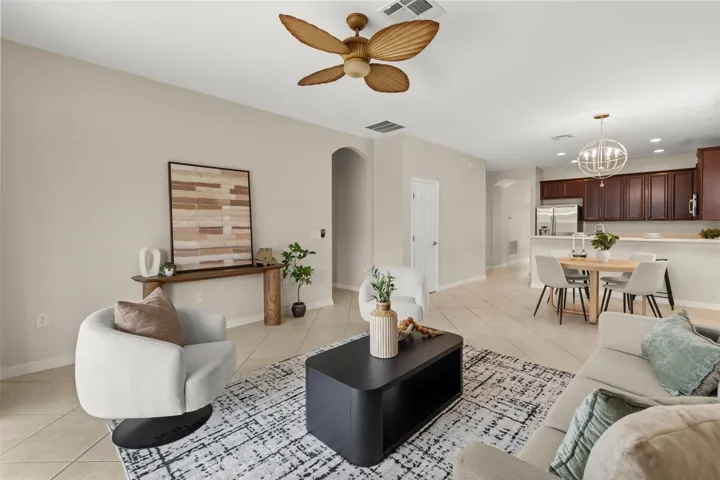 Bright and spacious, the family room is filled with natural light and opens through sliding glass doors to your private screened pool, covered lanai, and the perfect space for indoor-outdoor Florida living.