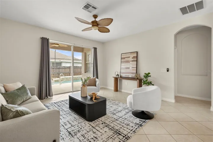 Bright and spacious, the family room is filled with natural light and opens through sliding glass doors to your private screened pool, covered lanai, and the perfect space for indoor-outdoor Florida living.