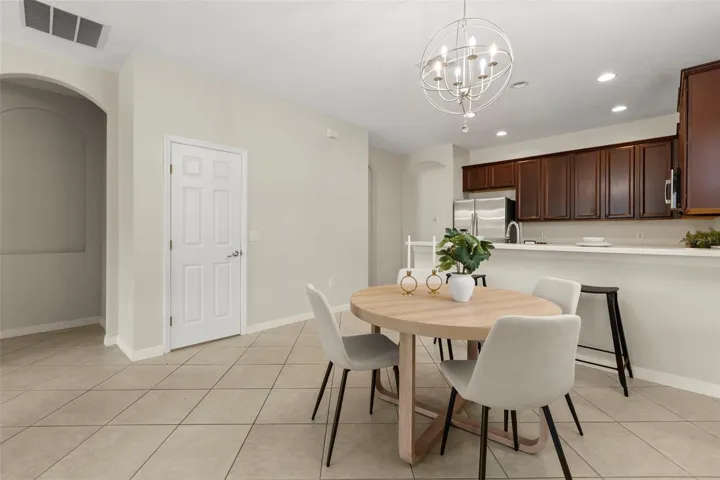 Open plan kitchen and family room with eat in nook and breakfast bar seating.