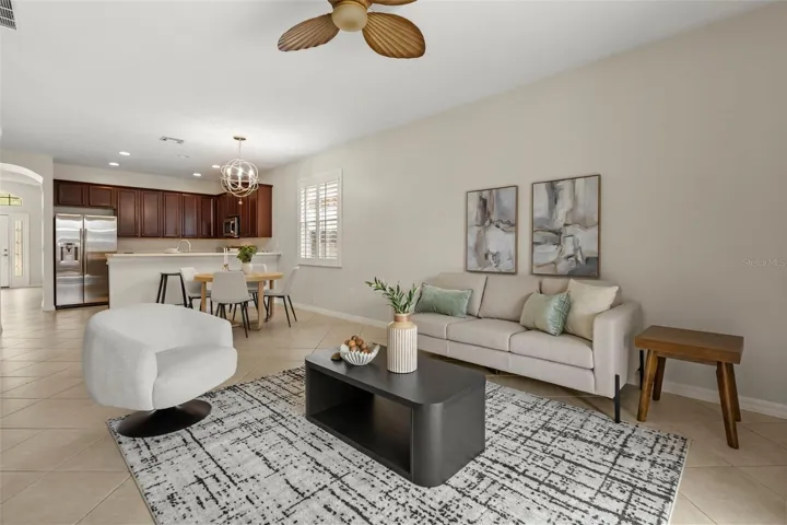 Bright and spacious, the family room is filled with natural light and opens through sliding glass doors to your private screened pool, covered lanai, and the perfect space for indoor-outdoor Florida living.