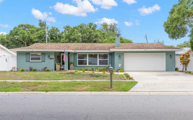 2405 Summerlin Drive is a spacious 3-bedroom, 2-bath single-story pool home with a covered front entry and attached two-car garage in Clearwater’s Morningside Estates.