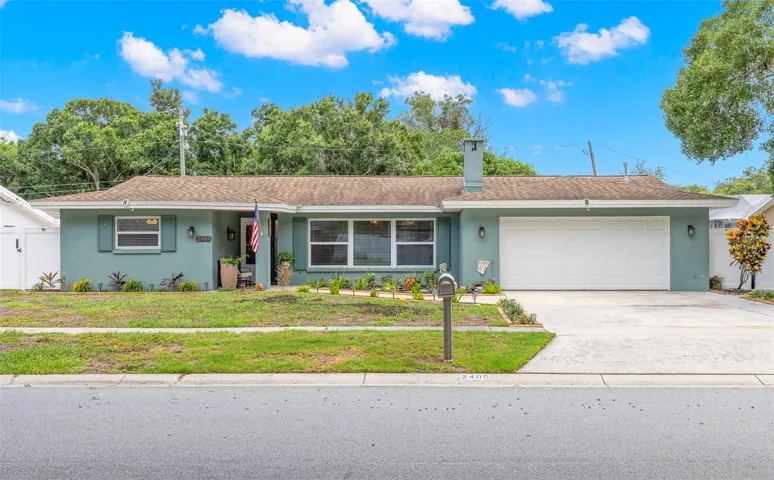 2405 Summerlin Drive is a spacious 3-bedroom, 2-bath single-story pool home with a covered front entry and attached two-car garage in Clearwater’s Morningside Estates.