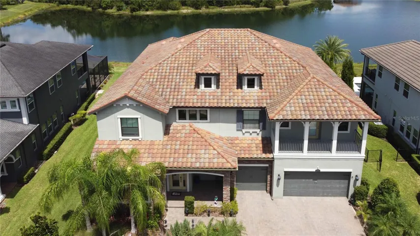 Aerial showing beautiful tile roof, pond in the back