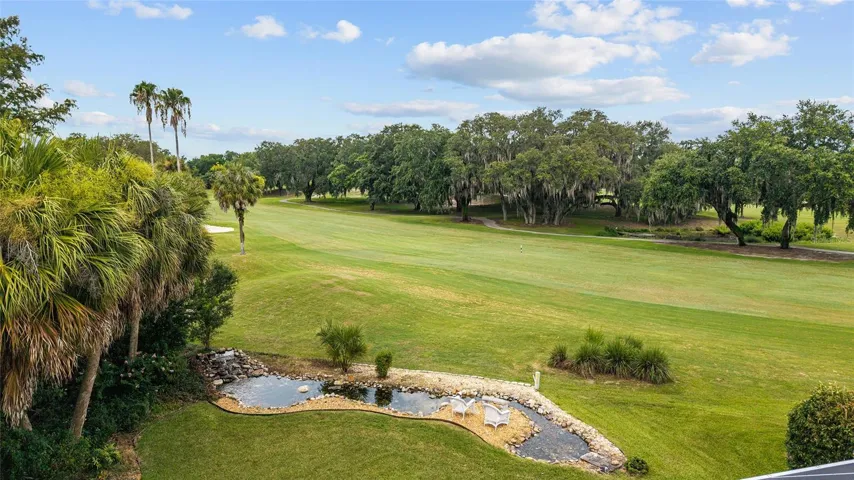 Beautiful backyard views extend across the golf course, offering a peaceful setting framed by established trees and landscaping.