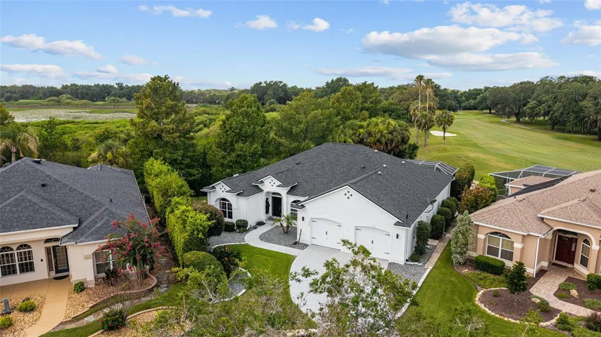 Elevated view showcases the home’s spacious homesite, mature trees, and open rear exposure overlooking the surrounding fairway.