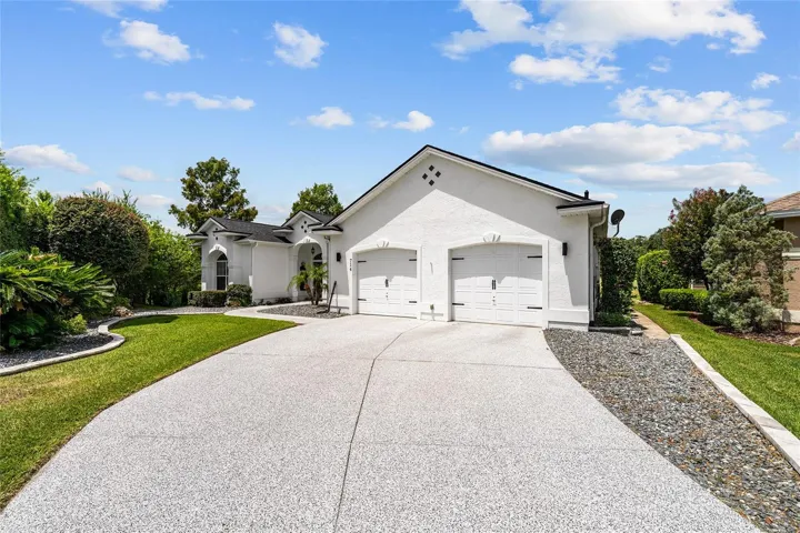A wide driveway leads to the XL attached garage (Fits 2 cars + 2 Golf carts!)  while the clean exterior, manicured landscaping, and attractive front elevation create welcoming curb appeal.