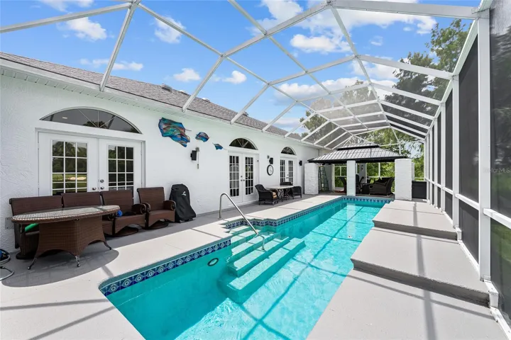 Enjoy resort-style outdoor living with a sparkling swimming LAP pool, expansive deck with both Shaded & Sunny areas in a full screened enclosure designed for relaxing and entertaining.