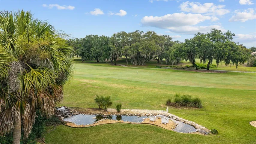 The property enjoys an unobstructed view of the fairway, (and fairway behind, complemented by mature palms, decorative landscaping, and a tranquil water feature.