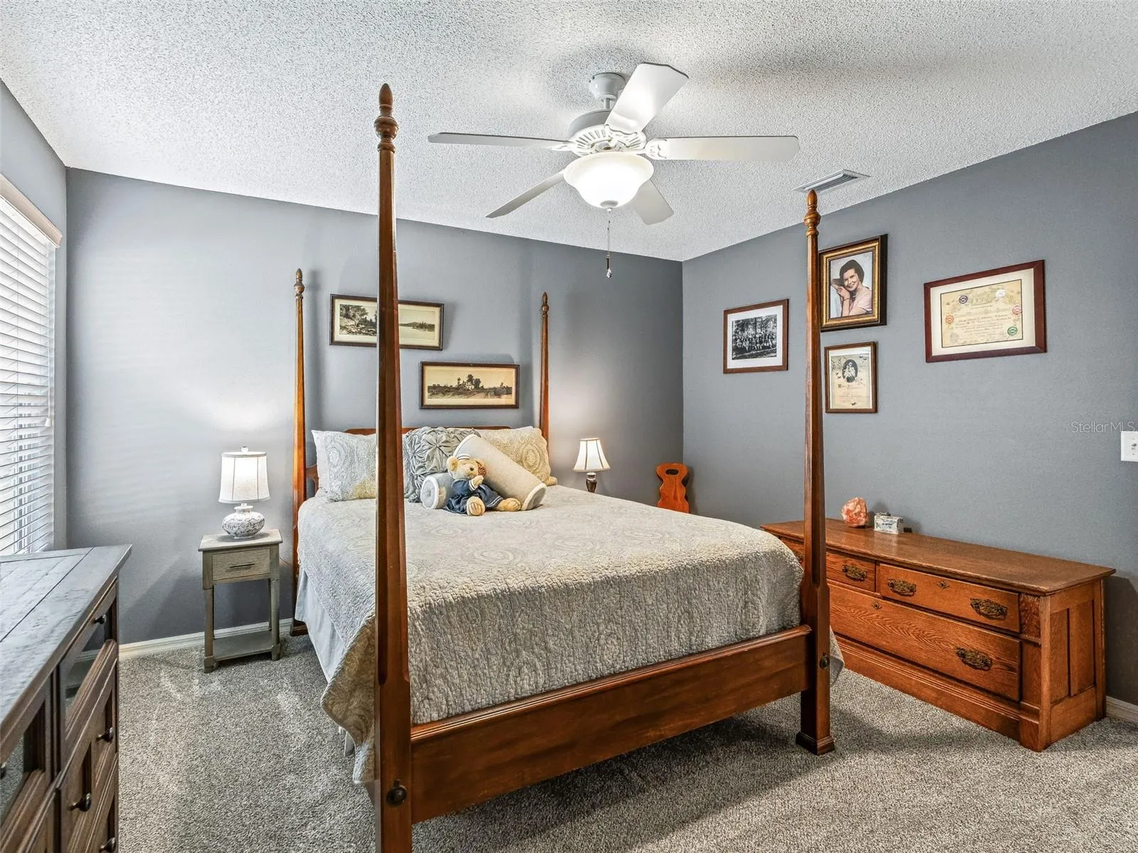 The spacious secondary bedroom with closet, provides room for a full furniture arrangement, along with a ceiling fan, and ample natural light.