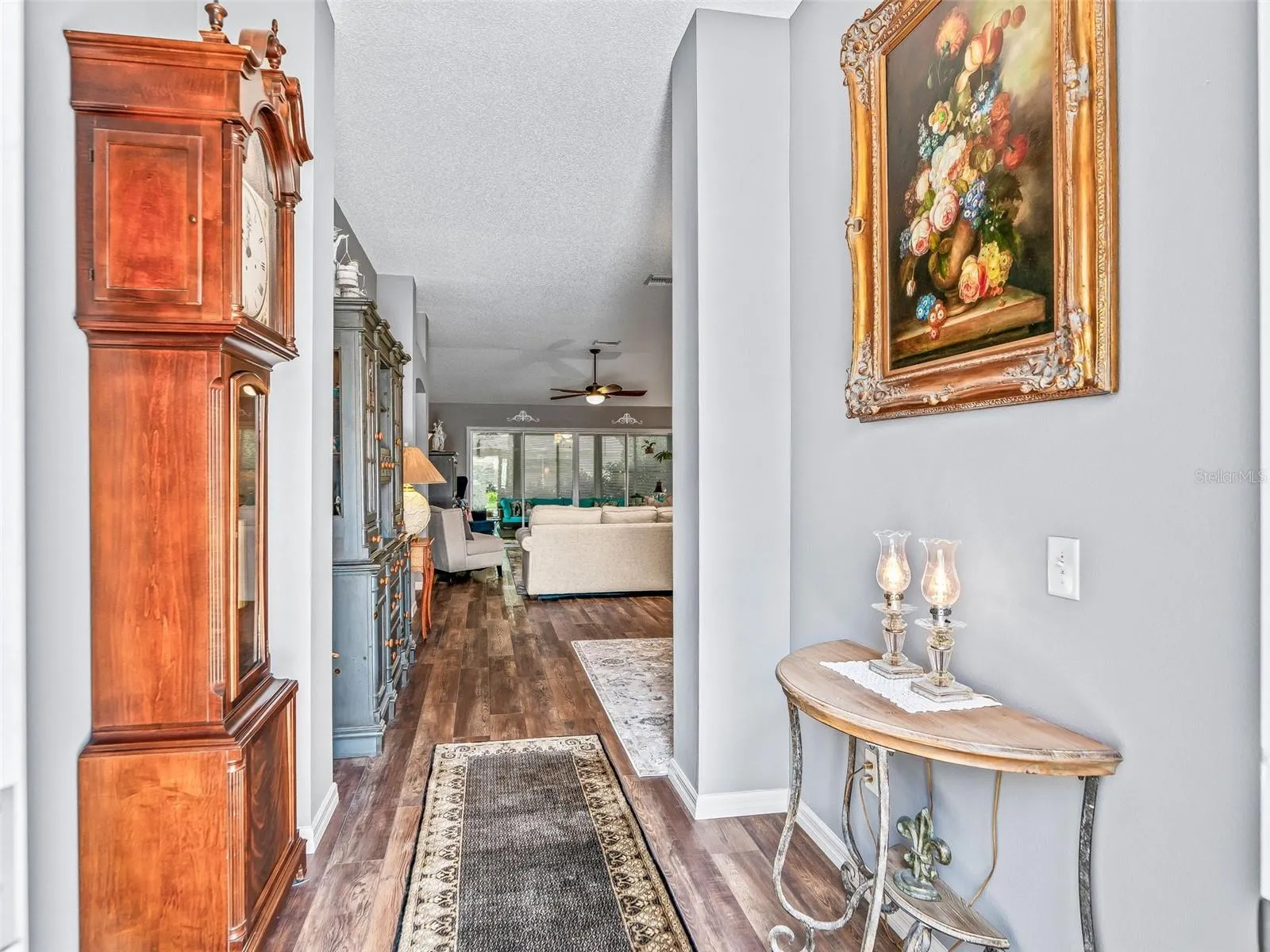 A long, inviting foyer with attractive wood-look High-end LVP flooring provides a clear sightline into the home’s open living spaces.