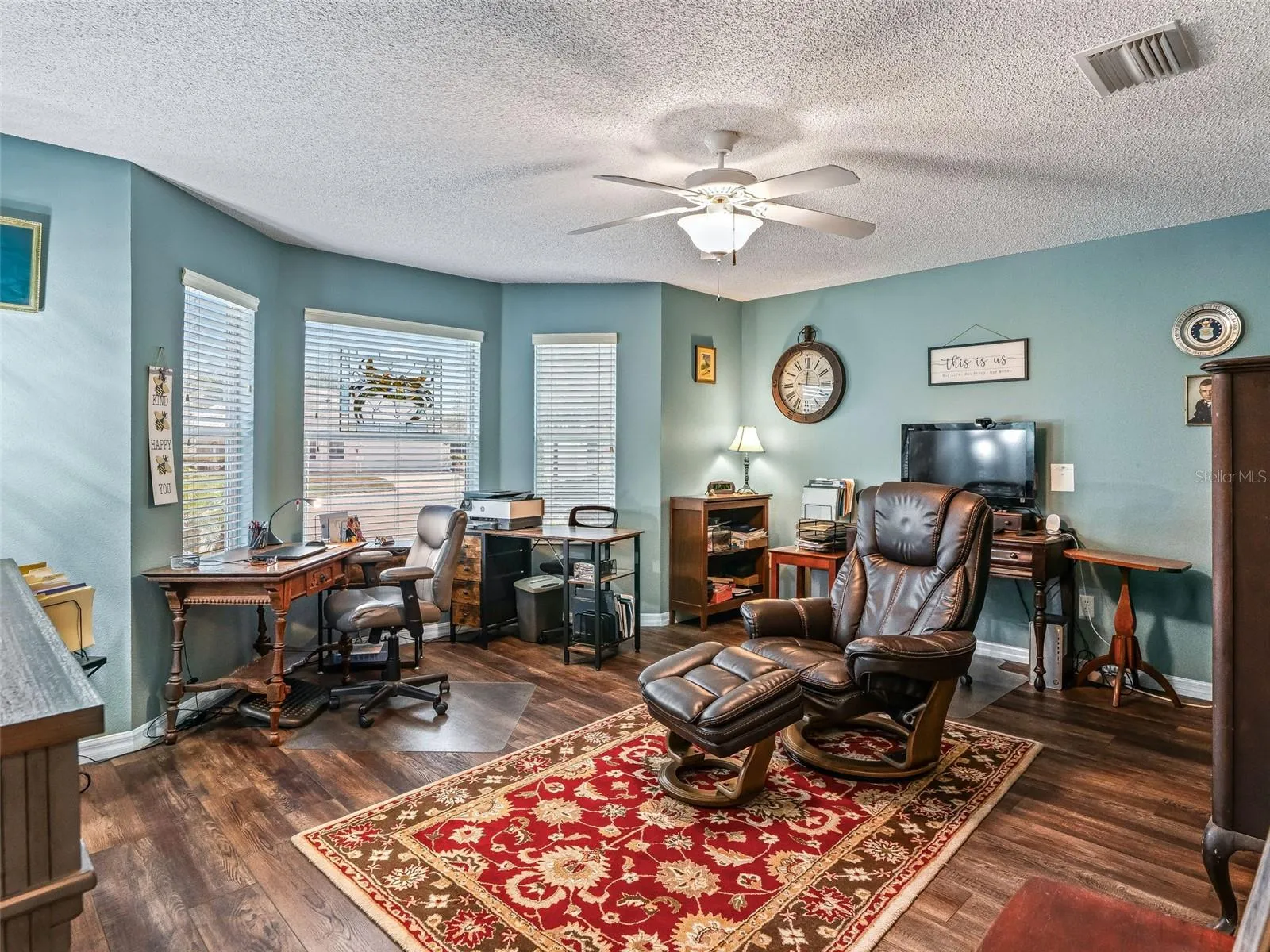 Spacious bonus room offers abundant natural light, wood-look flooring, a ceiling fan, and plenty of space for a home office, hobby room, 2nd Guest Bedroom, or additional sitting area.