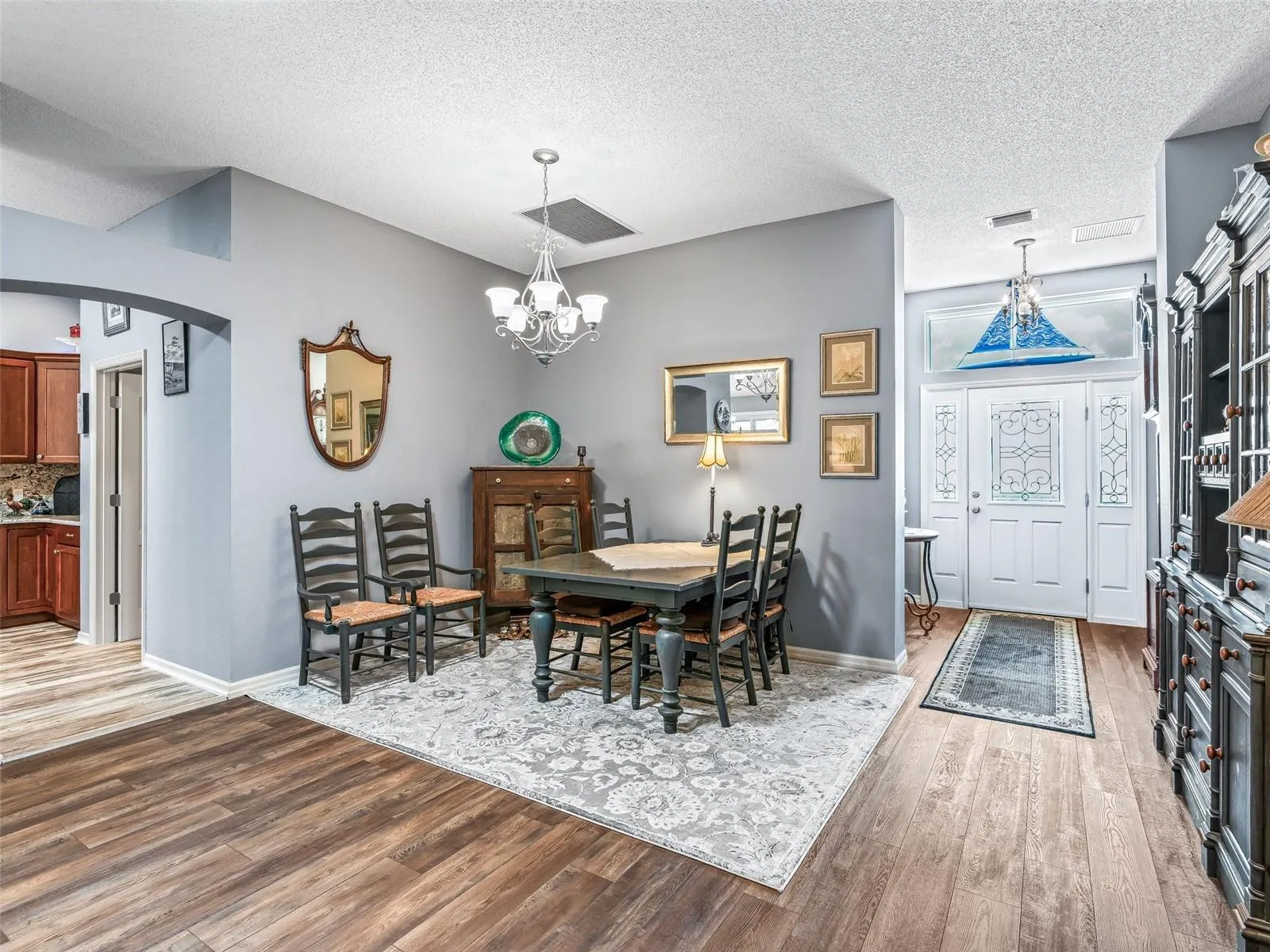 The dining area is thoughtfully positioned between the foyer and main living spaces, with ample room for a full-size table and accompanying furniture.