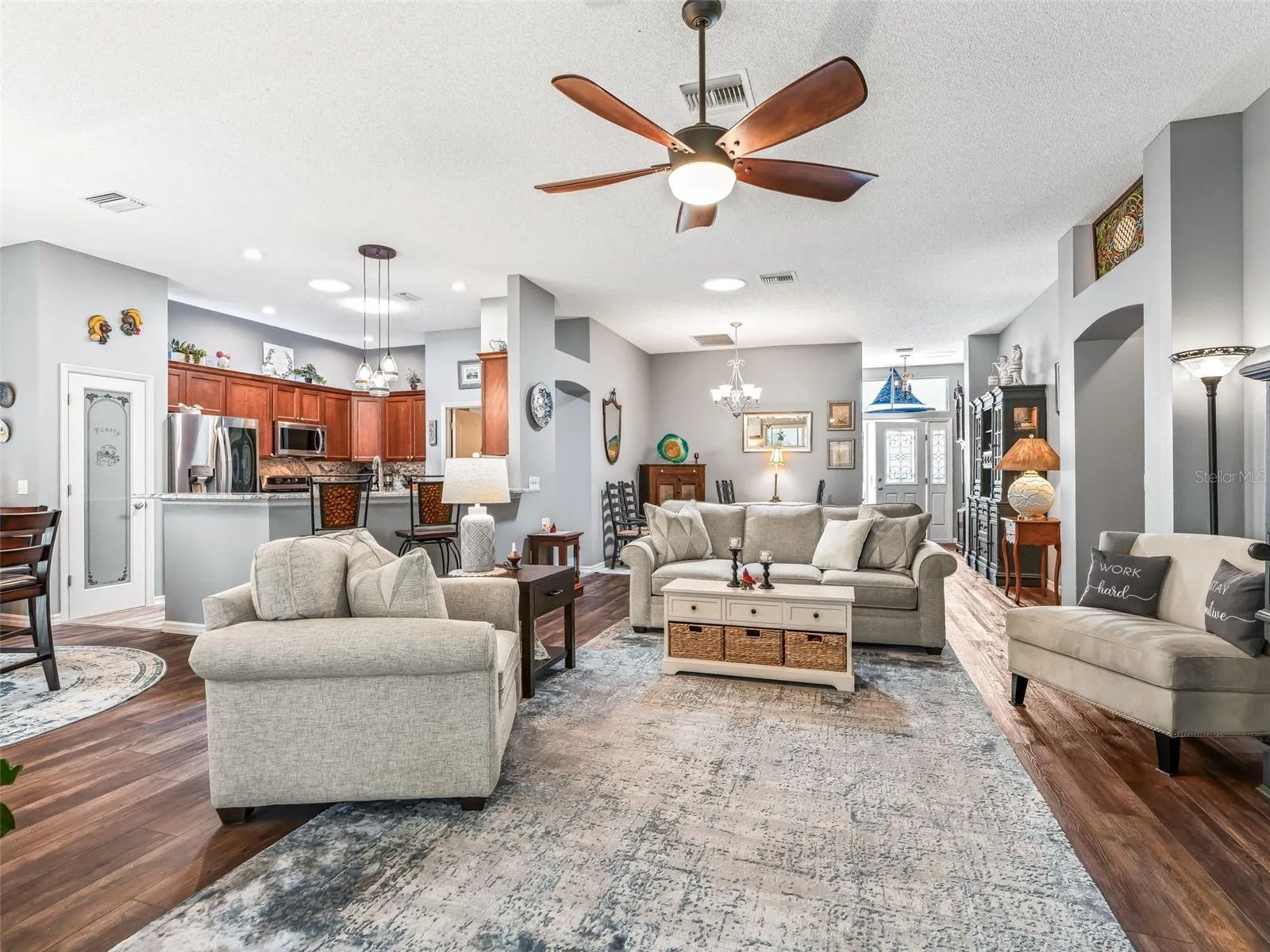 View from the living room showcases the home’s flowing layout, connecting the kitchen, dining area, and main gathering space for effortless entertaining.